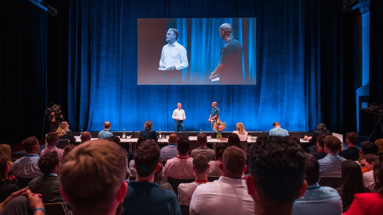 Bertelsmann invited top students from all over Europe to Berlin. Chief Human Resources Officer Immanuel Hermreck and moderator Amiaz Habtu welcomed the participants to the 14th edition of the &#39;Talent Meets Bertelsmann&#39; career event. (© Bertelsmann)